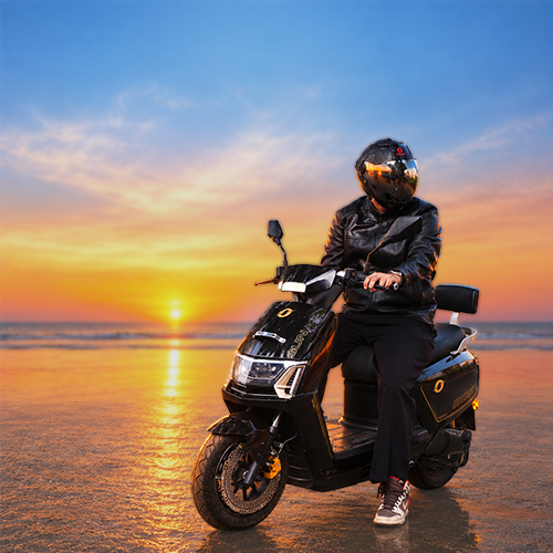 Rider on an Odysse electric scooter at the beach during sunset